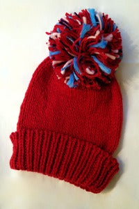 Image of hand knitted oversized pompom beanie